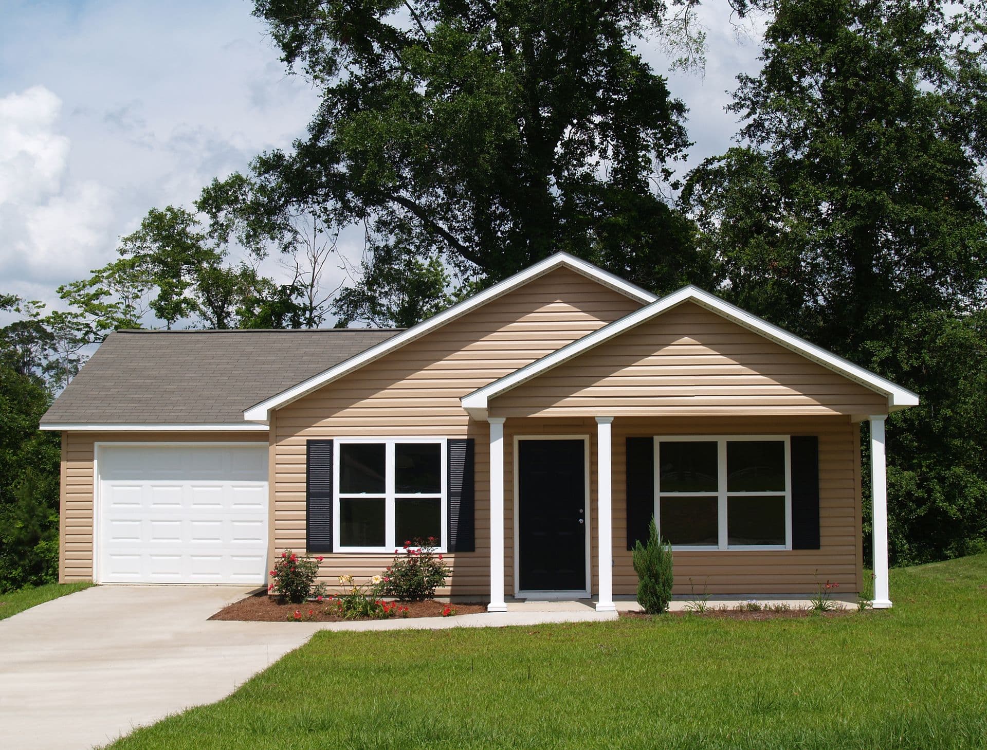 One story residential low income home with vinyl siding on the facade.